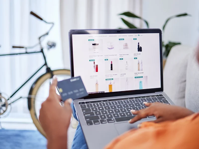 sri lanka ecommerce web development sri lanka an online customer using a credit card tp make a purchase on a website using a laptop in ecommerce in sri lanka